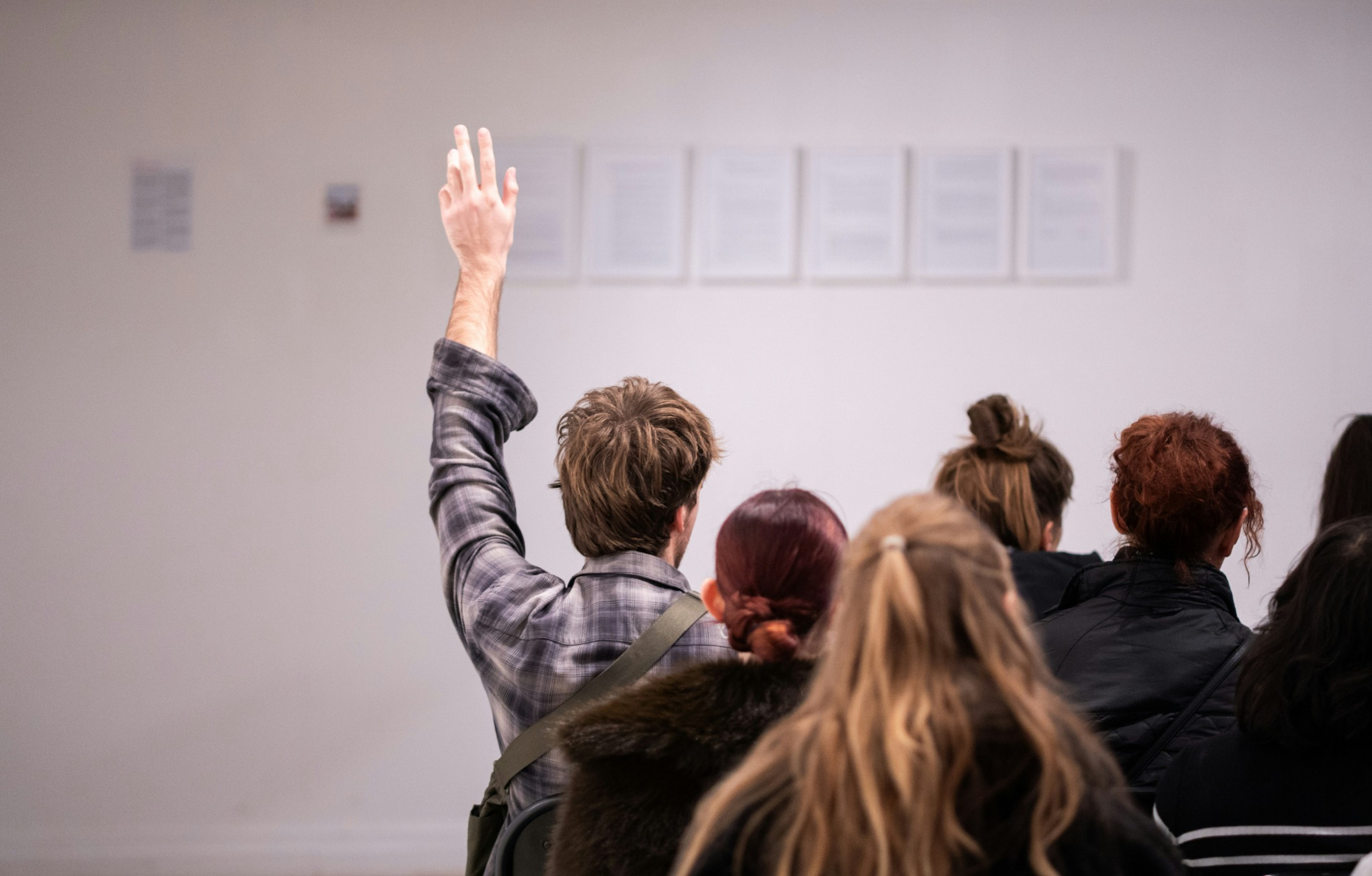 Person raising their hand during an AWS Savings Plans discussion
